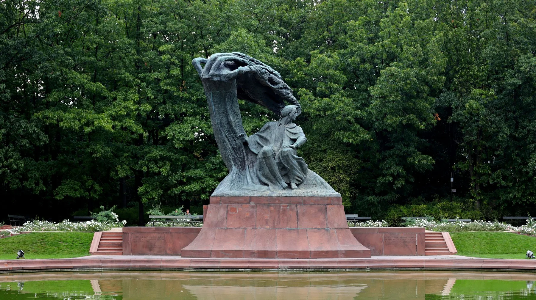 The bronze statue of Chopin in Łazienki Park, framed by trees